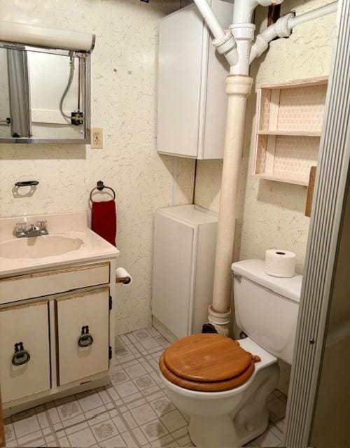 455 113th Ave NW, Coon Rapids, MN 55448 - bathroom featuring toilet, vanity, and tile patterned floors