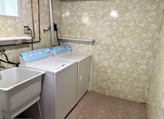 455 113th Ave NW, Coon Rapids, MN 55448 - washroom with wallpapered walls and separate washer and dryer
