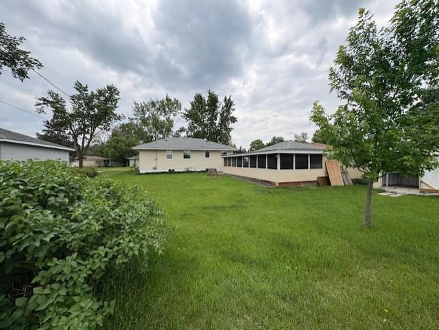 455 113th Ave NW, Coon Rapids, MN 55448 - view of green lawn featuring a sunroom