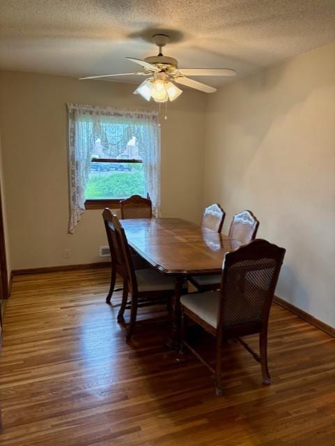 455 113th Ave NW, Coon Rapids, MN 55448 - dining area with a textured ceiling, wood finished floors, baseboards, and a ceiling fan