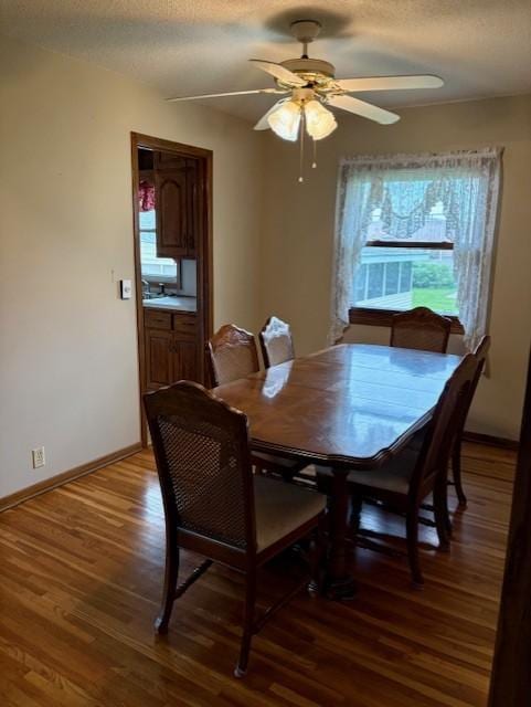 455 113th Ave NW, Coon Rapids, MN 55448 - dining area featuring wood finished floors, a ceiling fan, a textured ceiling, and baseboards
