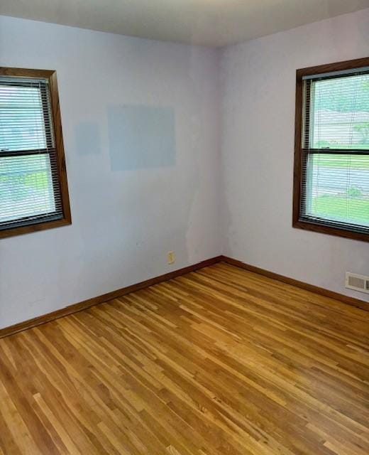 455 113th Ave NW, Coon Rapids, MN 55448 - unfurnished room featuring light wood-style flooring and baseboards