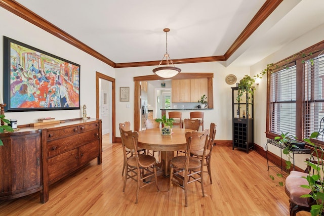3229 Fremont Ave S, Minneapolis, MN 55408 - dining area featuring light wood-type flooring, crown molding, baseboards, and healthy amount of natural light