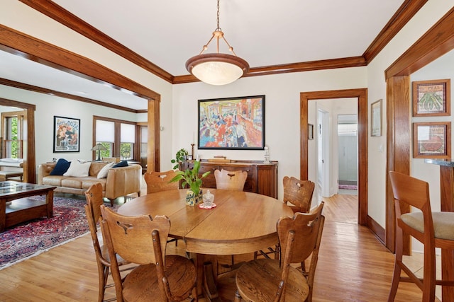 3229 Fremont Ave S, Minneapolis, MN 55408 - dining room featuring light wood-type flooring, crown molding, and baseboards