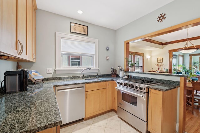 3229 Fremont Ave S, Minneapolis, MN 55408 - kitchen with stainless steel appliances, a sink, light brown cabinets, a peninsula, and dark stone countertops