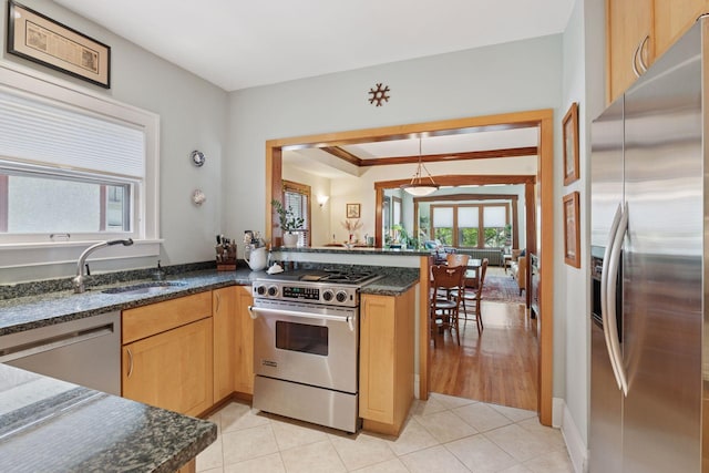 3229 Fremont Ave S, Minneapolis, MN 55408 - kitchen featuring stainless steel appliances, a sink, light brown cabinets, dark stone counters, and light tile patterned floors