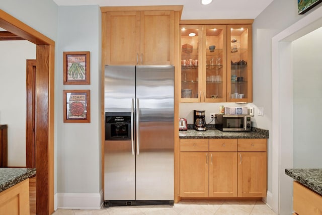 3229 Fremont Ave S, Minneapolis, MN 55408 - kitchen with appliances with stainless steel finishes, dark stone countertops, glass insert cabinets, baseboards, and recessed lighting
