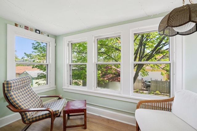 3229 Fremont Ave S, Minneapolis, MN 55408 - sunroom featuring plenty of natural light, wood finished floors, and baseboards