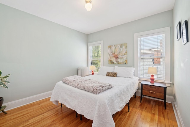 3229 Fremont Ave S, Minneapolis, MN 55408 - bedroom with radiator, hardwood / wood-style flooring, and baseboards