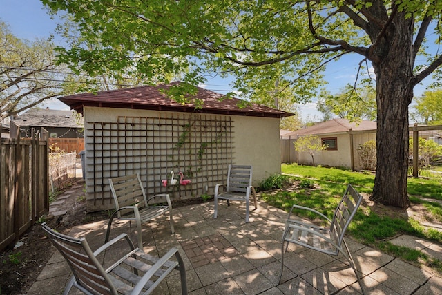 3229 Fremont Ave S, Minneapolis, MN 55408 - fenced backyard featuring a patio and an outdoor structure