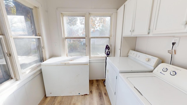 112 2nd St, Kiester, MN 56051 - laundry area with separate washer and dryer, cabinet space, light wood-style floors, and healthy amount of natural light