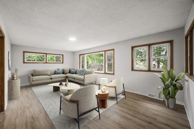 8235 Nicollet Ave S, Bloomington, MN 55420 - living area with a textured ceiling, wood finished floors, baseboards, and recessed lighting