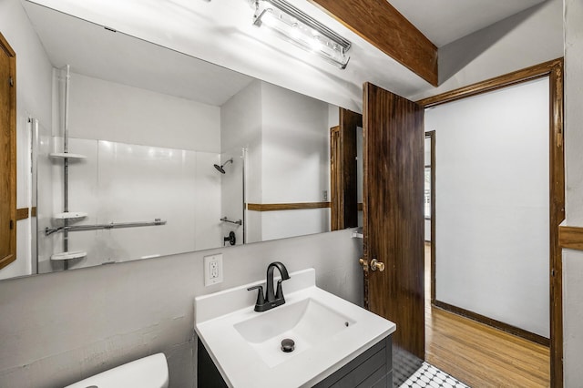 8235 Nicollet Ave S, Bloomington, MN 55420 - bathroom featuring toilet, vanity, wood finished floors, and a shower