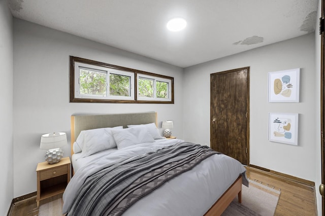 8235 Nicollet Ave S, Bloomington, MN 55420 - bedroom featuring baseboards, wood finished floors, and a closet