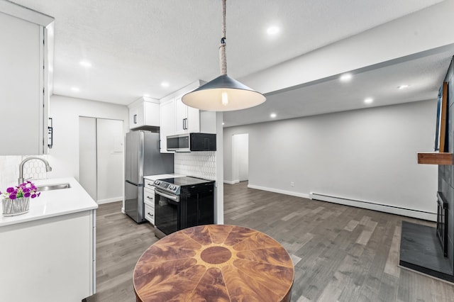 4584 Cedar Lake Rd S Unit 1, Saint Louis Park, MN 55416 - kitchen featuring stainless steel appliances, light wood-style flooring, white cabinetry, light countertops, and baseboard heating