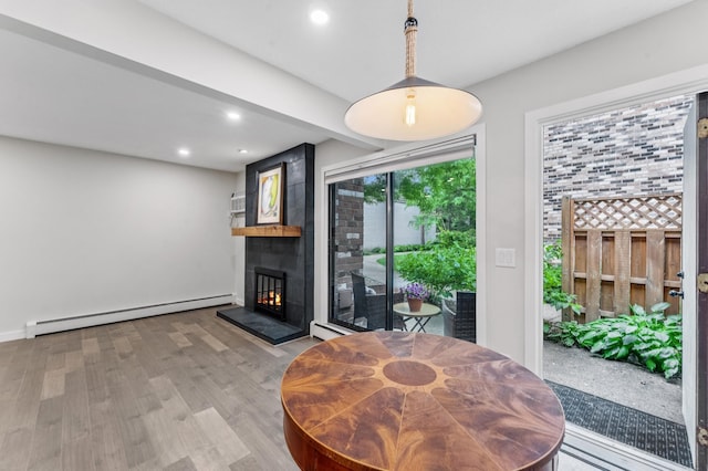 4584 Cedar Lake Rd S Unit 1, Saint Louis Park, MN 55416 - dining area with a baseboard radiator, wood finished floors, a large fireplace, and recessed lighting
