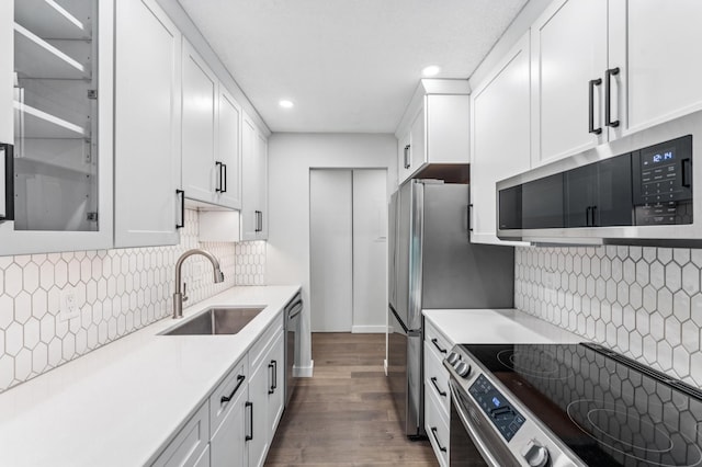 4584 Cedar Lake Rd S Unit 1, Saint Louis Park, MN 55416 - kitchen with stainless steel appliances, dark wood finished floors, white cabinetry, recessed lighting, and light countertops