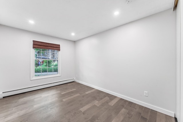 4584 Cedar Lake Rd S Unit 1, Saint Louis Park, MN 55416 - spare room with baseboard heating, wood finished floors, and recessed lighting