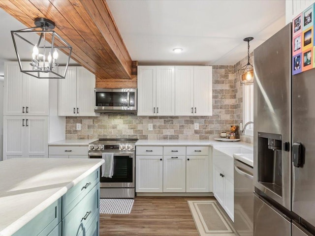5335 Pine Beach Rd, Brainerd, MN 56401 - kitchen featuring stainless steel appliances, a sink, white cabinets, light countertops, and tasteful backsplash