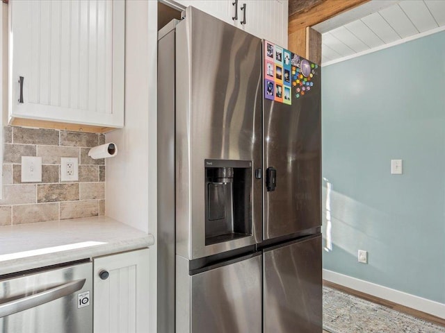 5335 Pine Beach Rd, Brainerd, MN 56401 - kitchen featuring appliances with stainless steel finishes, decorative backsplash, and white cabinets