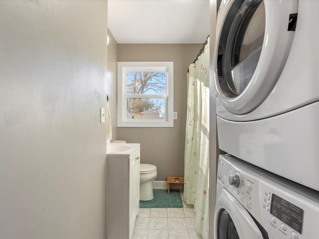 5335 Pine Beach Rd, Brainerd, MN 56401 - laundry room with stacked washer and clothes dryer, baseboards, and light tile patterned floors