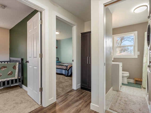 5335 Pine Beach Rd, Brainerd, MN 56401 - ensuite bathroom with toilet, baseboards, and wood finished floors