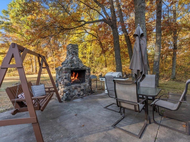 5335 Pine Beach Rd, Brainerd, MN 56401 - view of patio with an outdoor stone fireplace, outdoor dining space, and area for grilling