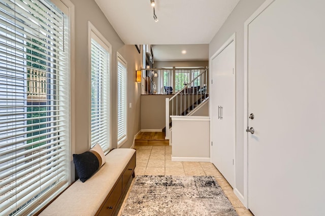 5691 Birch Trl, Shoreview, MN 55126 - entrance foyer with light tile patterned floors, baseboards, and rail lighting