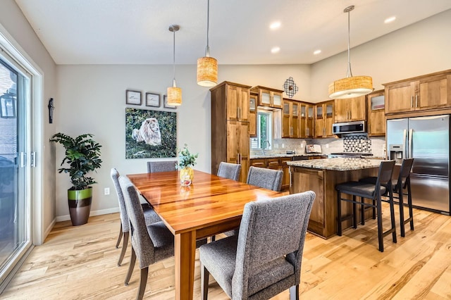 5691 Birch Trl, Shoreview, MN 55126 - dining room with lofted ceiling, light wood-style floors, and recessed lighting