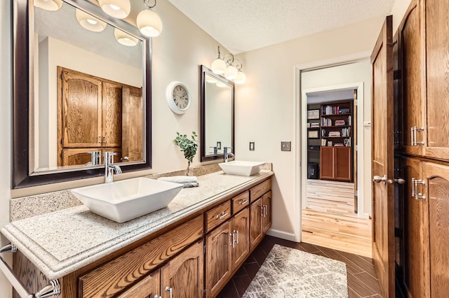 5691 Birch Trl, Shoreview, MN 55126 - bathroom featuring double vanity and a textured ceiling
