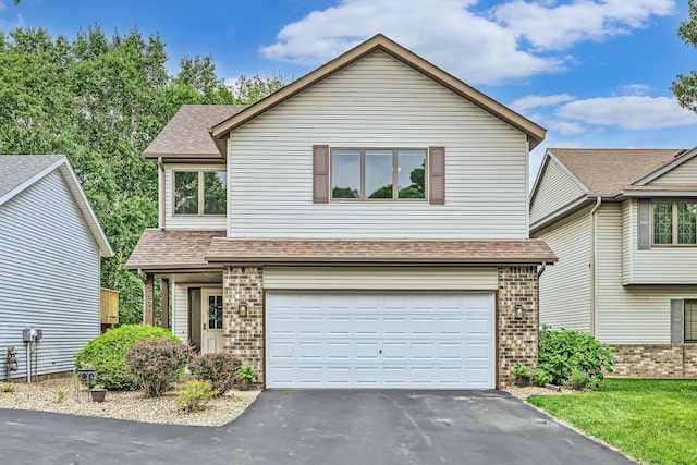 5691 Birch Trl, Shoreview, MN 55126 - view of front facade featuring driveway, an attached garage, brick siding, and a shingled roof
