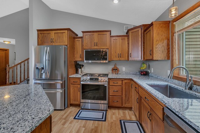 823 Morningside Loop, Saint Joseph, MN 56374 - kitchen featuring appliances with stainless steel finishes, brown cabinets, light wood-type flooring, and high vaulted ceiling