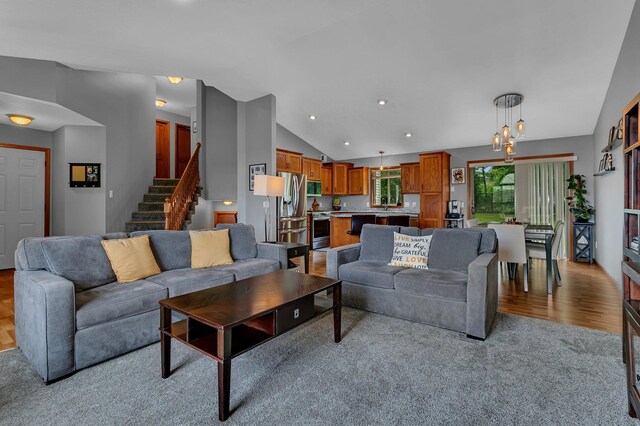 823 Morningside Loop, Saint Joseph, MN 56374 - carpeted living room with vaulted ceiling, stairway, a chandelier, and recessed lighting