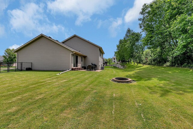 823 Morningside Loop, Saint Joseph, MN 56374 - rear view of house with a fire pit, a patio, and a gate