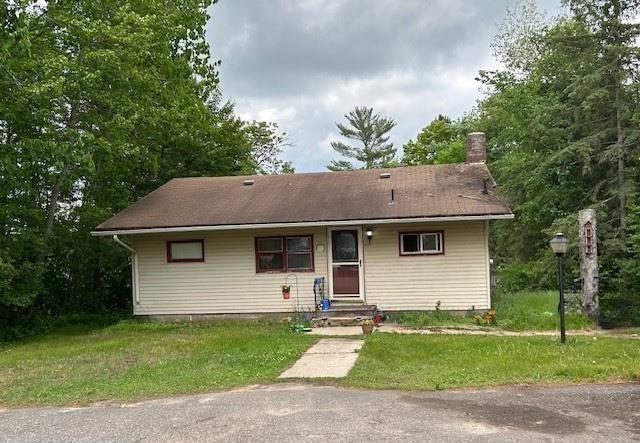 31074 State Highway 65, Greenway Twp, MN 55775 - view of front of house featuring a chimney and a front yard
