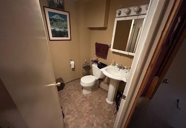 31074 State Highway 65, Greenway Twp, MN 55775 - half bathroom featuring toilet, tile patterned floors, and baseboards