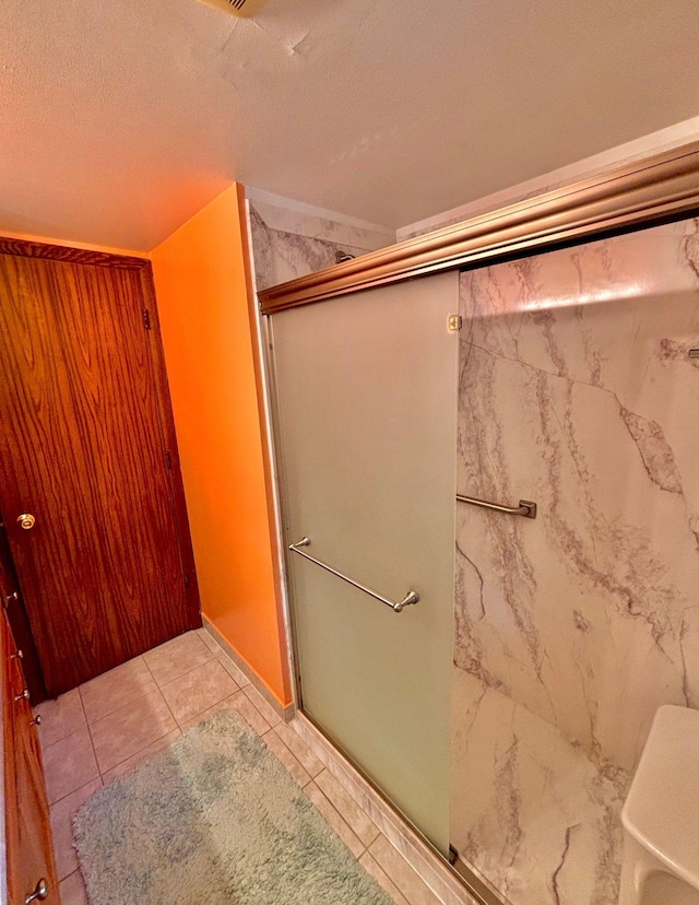 4488 Konieska Rd, Moose Lake, MN 55767 - bathroom with a shower with shower door, tile patterned floors, and a textured ceiling