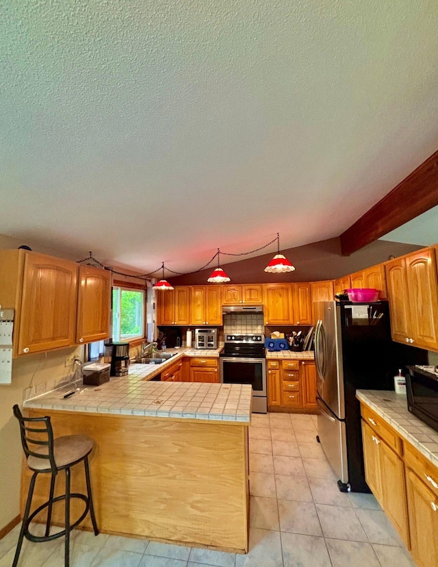 4488 Konieska Rd, Moose Lake, MN 55767 - kitchen with stainless steel appliances, a peninsula, tile countertops, a textured ceiling, and light tile patterned floors