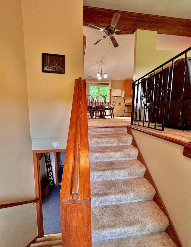 4488 Konieska Rd, Moose Lake, MN 55767 - stairway featuring a ceiling fan, a chandelier, and carpet