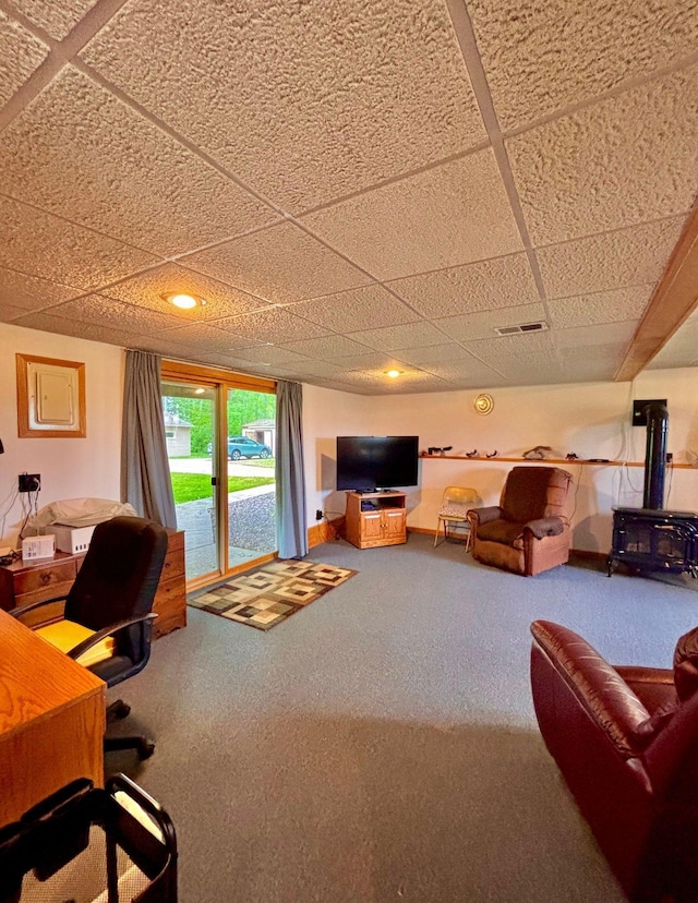 4488 Konieska Rd, Moose Lake, MN 55767 - carpeted living area with a paneled ceiling and a wood stove