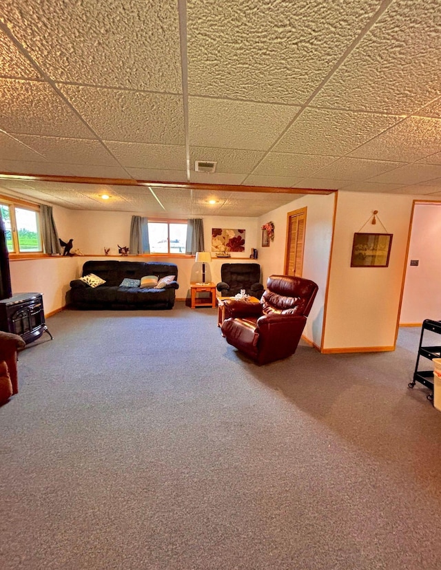 4488 Konieska Rd, Moose Lake, MN 55767 - living area with carpet floors, a wood stove, a paneled ceiling, and a fireplace
