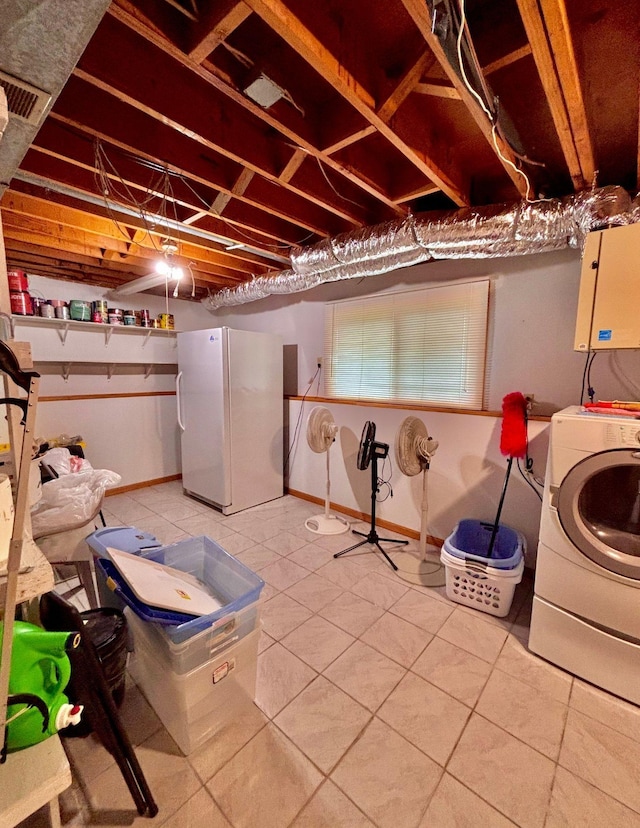 4488 Konieska Rd, Moose Lake, MN 55767 - basement with freestanding refrigerator, washer / dryer, and light tile patterned flooring