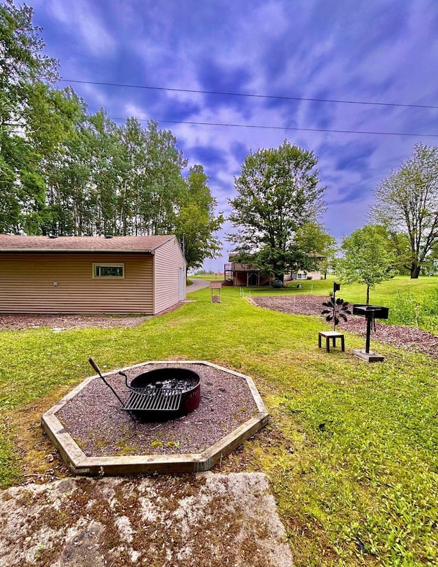4488 Konieska Rd, Moose Lake, MN 55767 - view of grassy yard featuring an outdoor fire pit and an outdoor structure