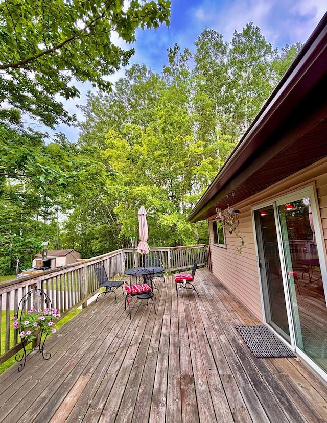 4488 Konieska Rd, Moose Lake, MN 55767 - deck with outdoor dining area and view of scattered trees
