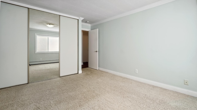3540 Hennepin Ave Unit 309, Minneapolis, MN 55408 - unfurnished bedroom featuring baseboard heating, carpet, crown molding, baseboards, and a closet