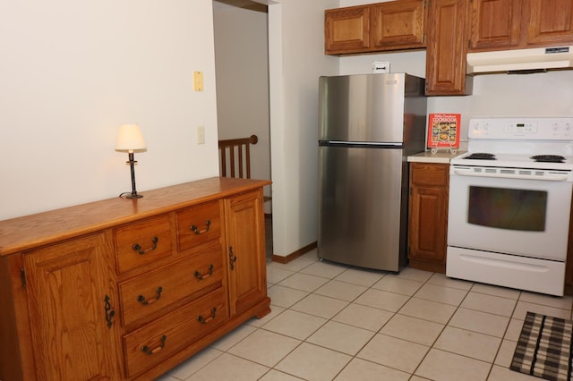 7971 Upper 145th St W, Apple Valley, MN 55124 - kitchen featuring white range with electric stovetop, under cabinet range hood, freestanding refrigerator, brown cabinetry, and light countertops