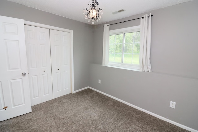 7971 Upper 145th St W, Apple Valley, MN 55124 - unfurnished bedroom with carpet floors, a chandelier, and a closet