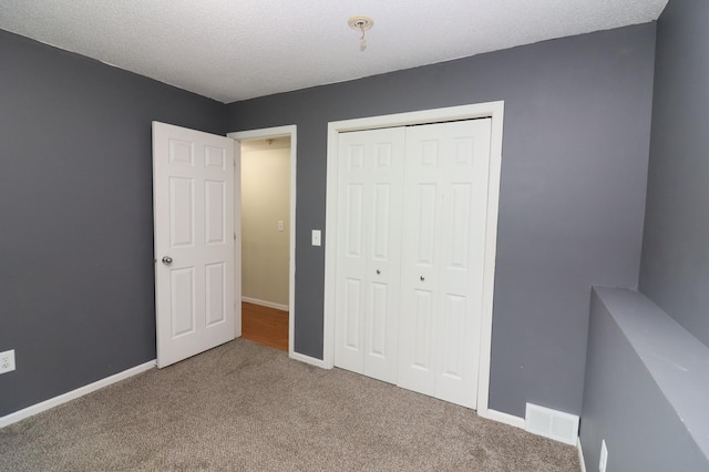 7971 Upper 145th St W, Apple Valley, MN 55124 - unfurnished bedroom with carpet flooring, a closet, and a textured ceiling