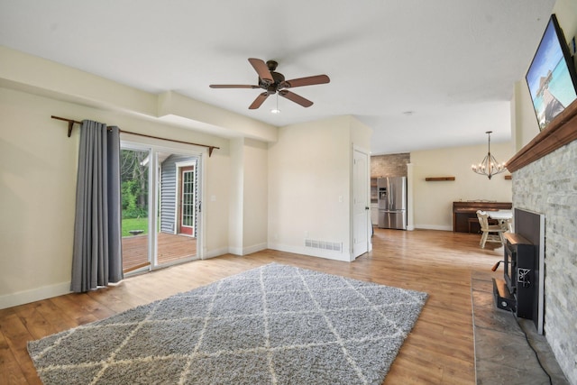 2256 40th Ave Unit X, East Farmington, WI 54020 - unfurnished living room with a ceiling fan, wood finished floors, a chandelier, and baseboards