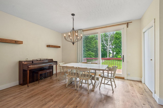 2256 40th Ave Unit X, East Farmington, WI 54020 - dining room with light wood-type flooring, a chandelier, and baseboards